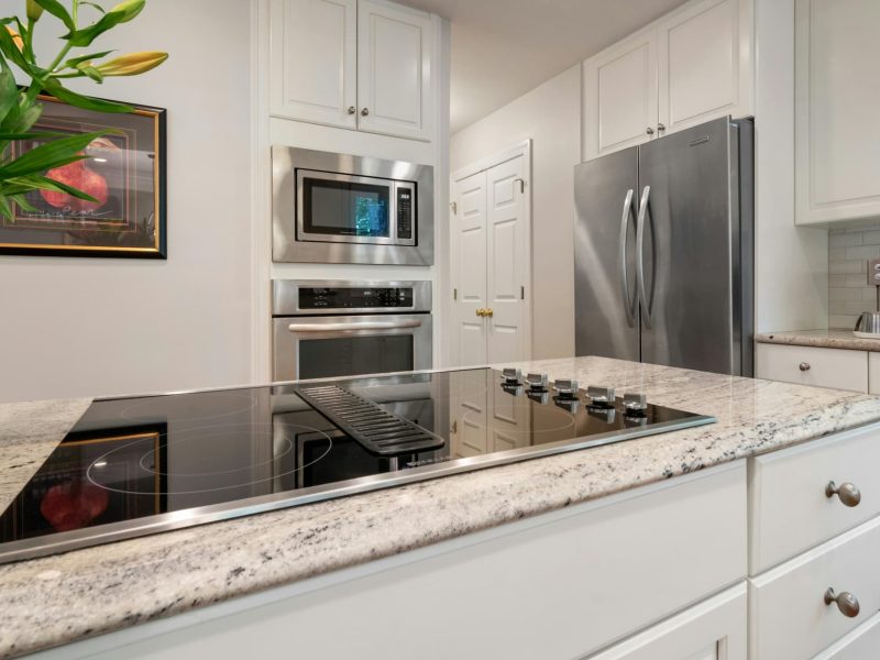 Cooktop repair technician fixing kitchen stove top