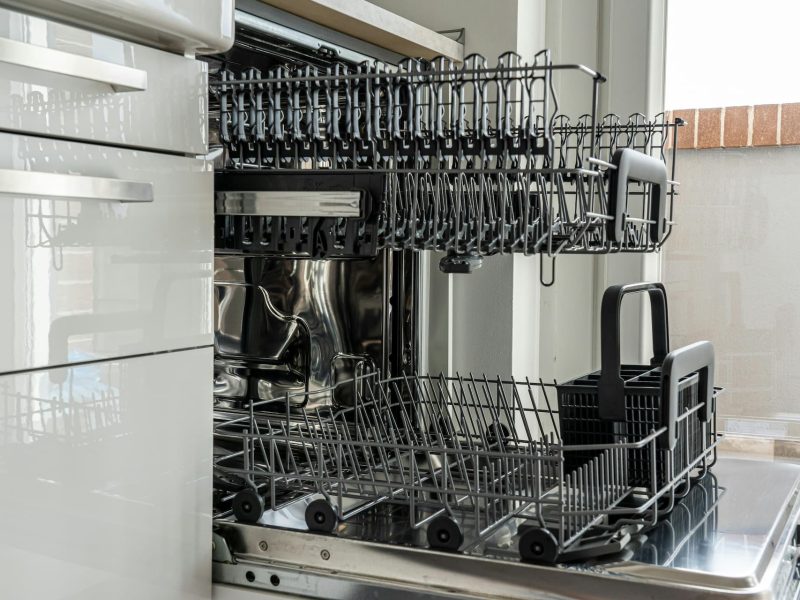 Dishwasher repair service technician working under sink