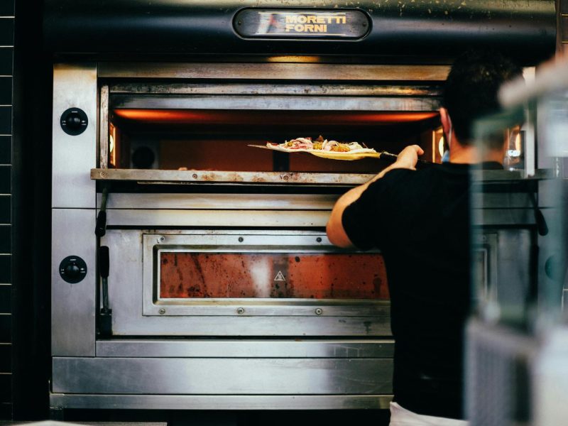 Oven repair technician fixing heating element